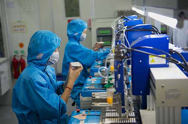 Chinese Workers Testing Emission in Lab