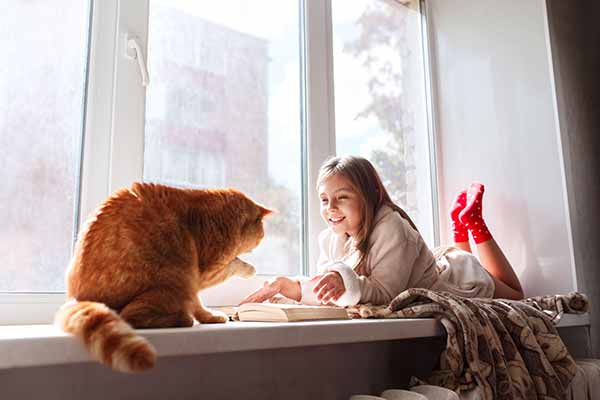 Weatherization Program Photo of Young Girl in Front of Window