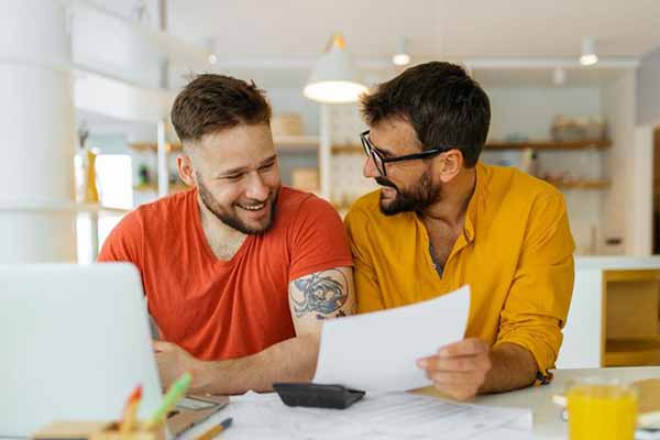 Solar Panels Two Men Looking at Energy Savings on Bill