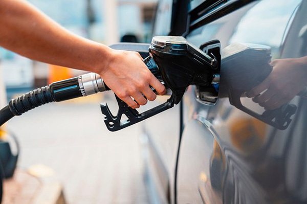 Man Pumping Gas Into Car From Pump Man Pumping Gas Into Car From Pump