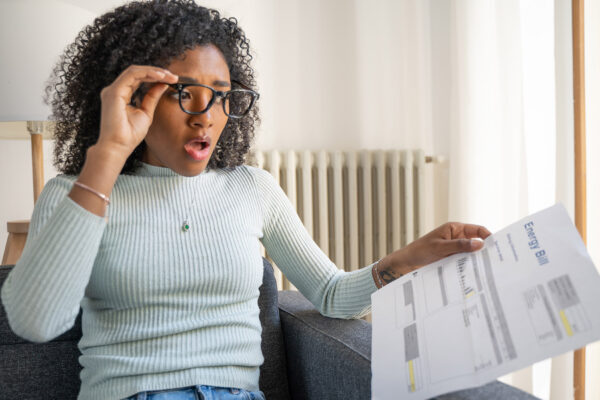 EnergySavings.com vs. Choose Energy Image of Woman Comparing Bills