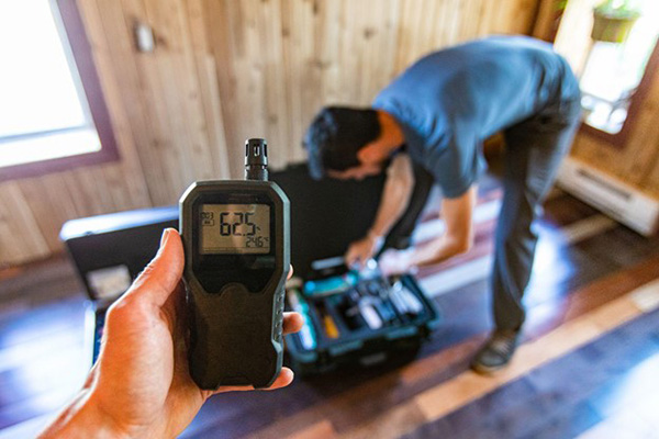 Technicians Measuring Air Quality Man Holds Meter in Hand