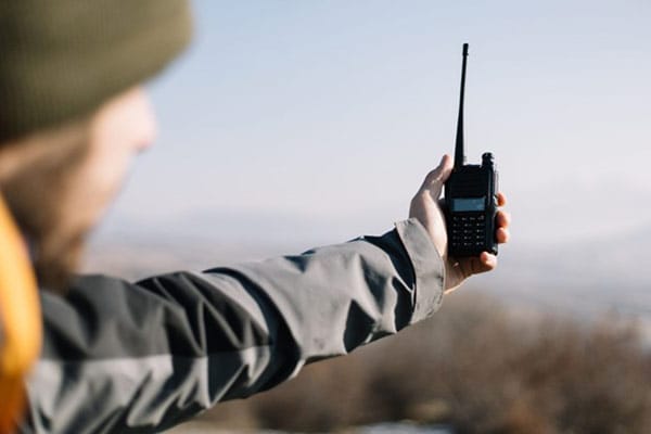 Man Checks Transmitter Hold in Hand