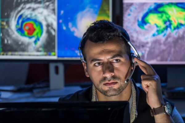 A meteorologist making a phone call
